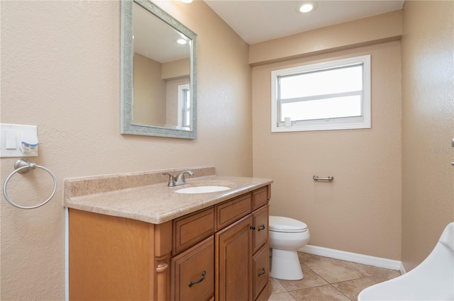 bathroom featuring vanity, tile flooring, and toilet