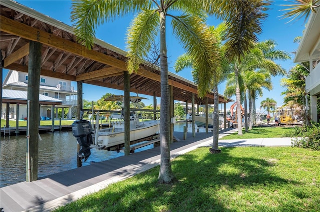 view of dock with a water view and a yard