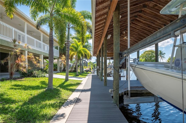 view of dock featuring a lawn