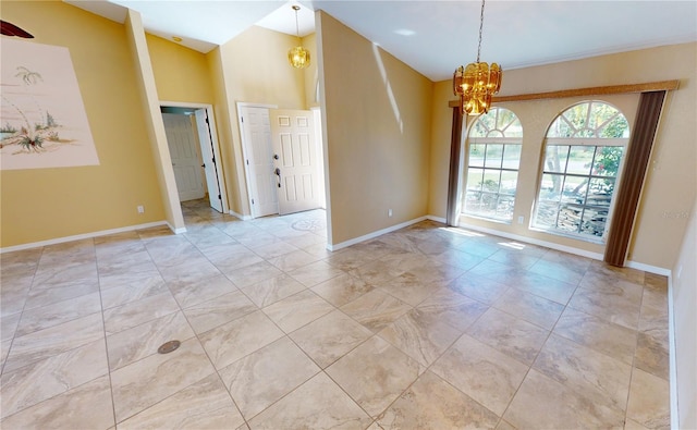 tiled empty room with a notable chandelier and a towering ceiling