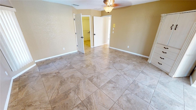 unfurnished bedroom with ceiling fan and light tile flooring