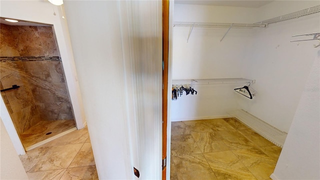 walk in closet featuring light tile floors