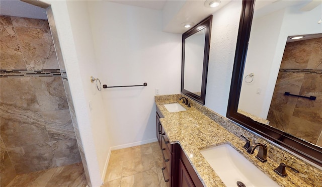 bathroom featuring tile floors and dual vanity