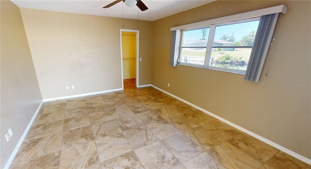 tiled empty room with ceiling fan