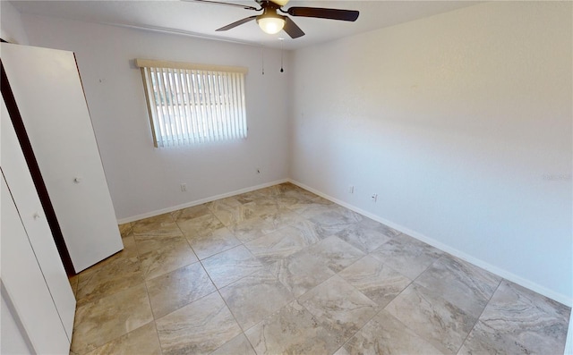 tiled empty room with ceiling fan