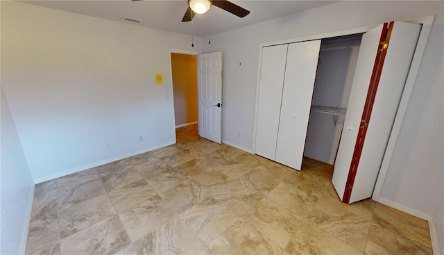 unfurnished bedroom featuring light tile floors and ceiling fan