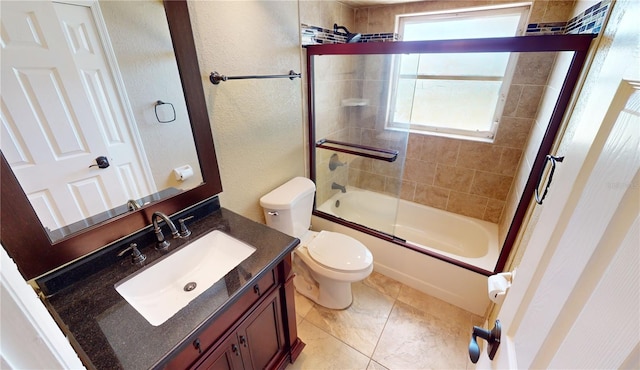 full bathroom with vanity, combined bath / shower with glass door, tile floors, and toilet