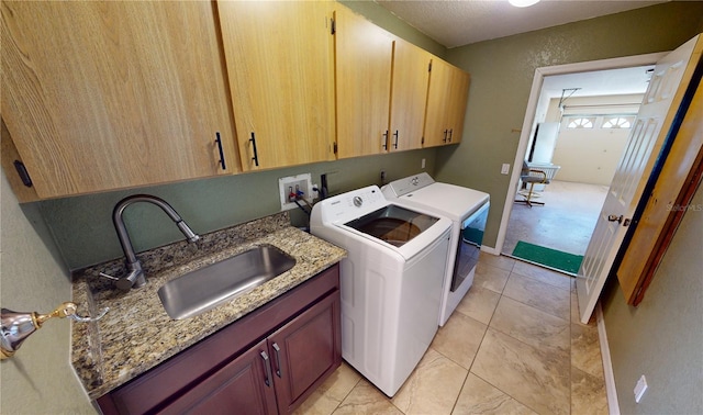 laundry area featuring washer hookup, light tile floors, cabinets, independent washer and dryer, and sink