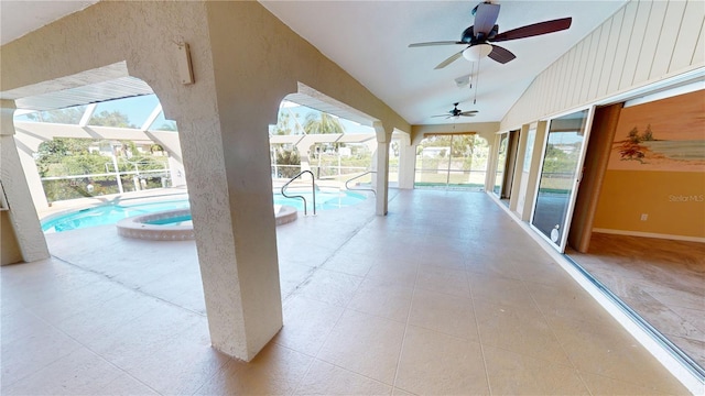 view of terrace featuring ceiling fan and a swimming pool with hot tub