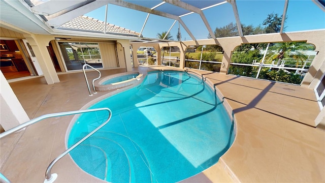 view of pool featuring a patio area, an in ground hot tub, and glass enclosure