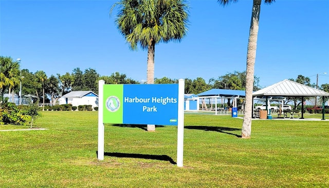 community / neighborhood sign featuring a lawn