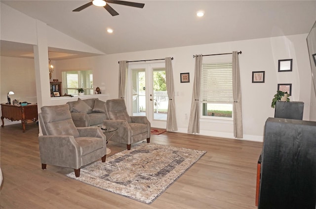 living room with french doors, hardwood / wood-style floors, ceiling fan, and vaulted ceiling