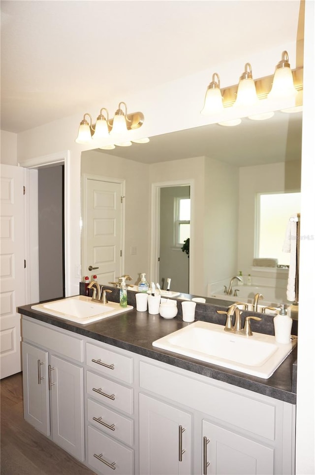 bathroom featuring hardwood / wood-style floors and dual vanity