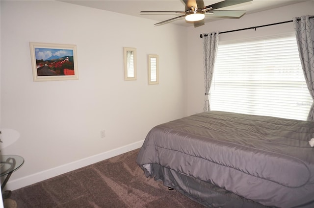 carpeted bedroom featuring multiple windows and ceiling fan