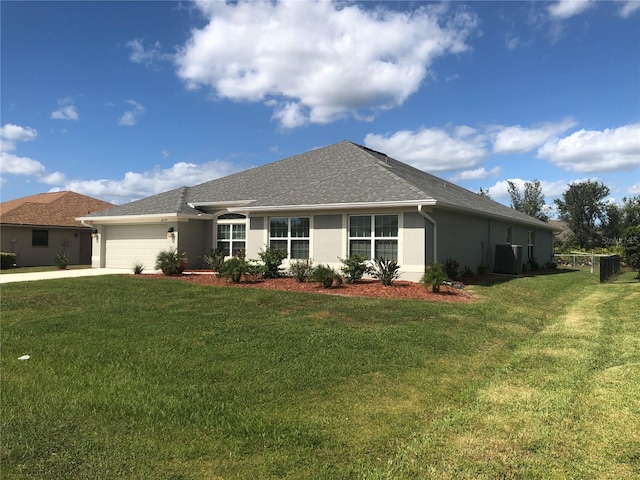 view of front of property with a front yard and a garage