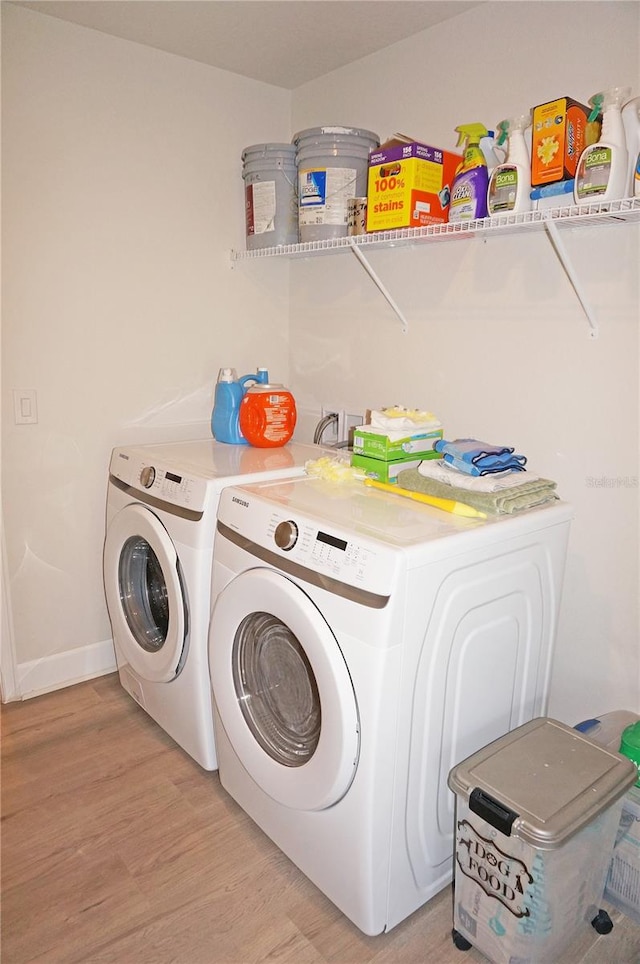 laundry room with washer hookup, light hardwood / wood-style floors, and independent washer and dryer