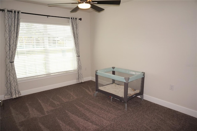 carpeted empty room featuring plenty of natural light and ceiling fan