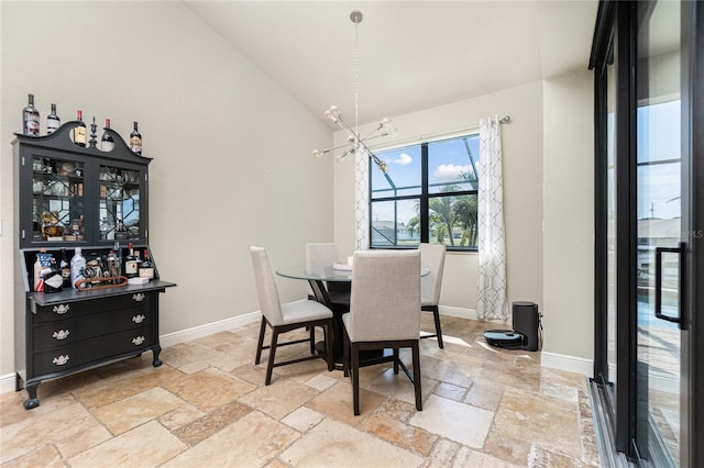 tiled dining area with an inviting chandelier and lofted ceiling