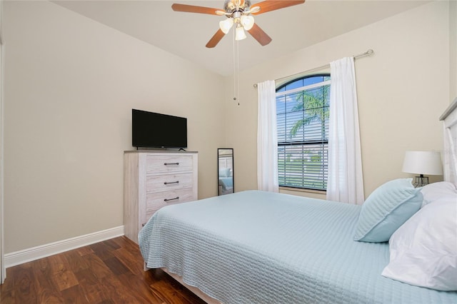 bedroom with dark hardwood / wood-style flooring and ceiling fan