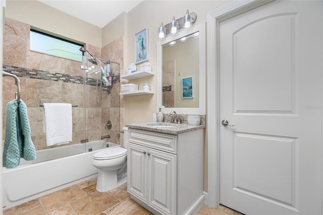 full bathroom with vanity, tile floors, toilet, and tiled shower / bath