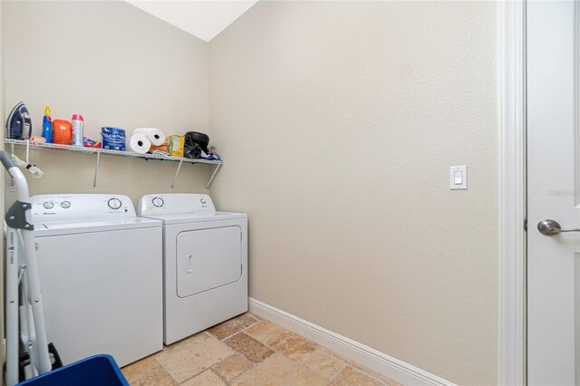 clothes washing area with independent washer and dryer and light tile flooring