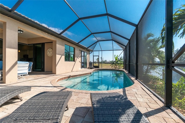 view of pool with a patio and a lanai