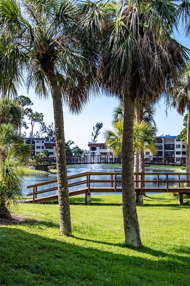 view of property's community featuring a water view and a yard