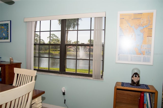 bedroom with a water view and multiple windows