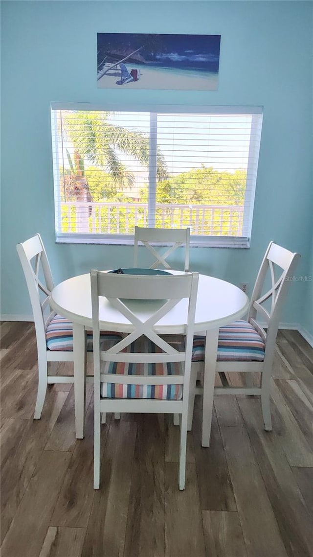 dining area with dark hardwood / wood-style flooring