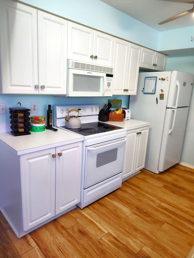 kitchen with white cabinets, light hardwood / wood-style flooring, ceiling fan, and white appliances