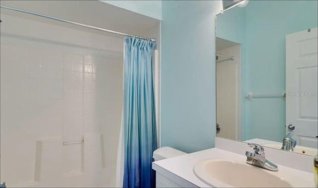 bathroom with toilet and vanity