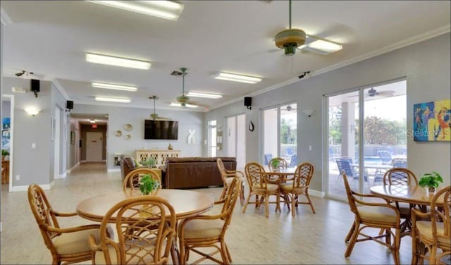 dining space with ceiling fan and crown molding