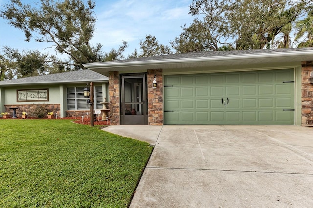 view of front of property featuring a front yard and a garage