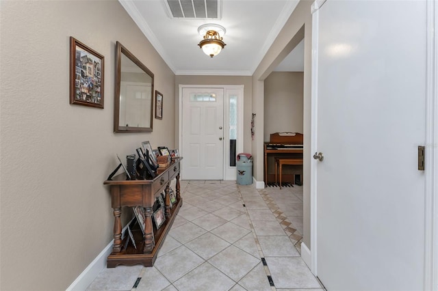 foyer with light tile floors and crown molding