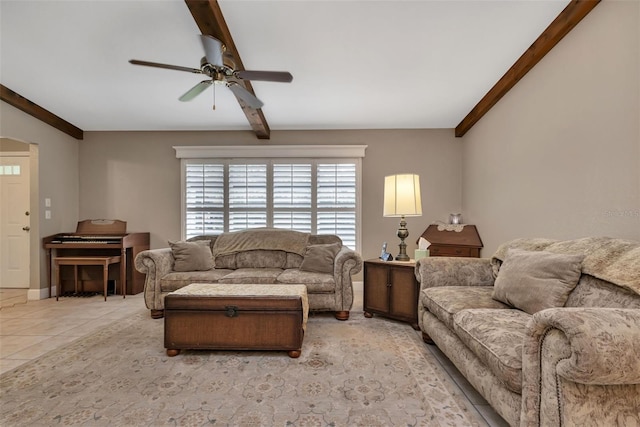 tiled living room featuring ceiling fan and beamed ceiling