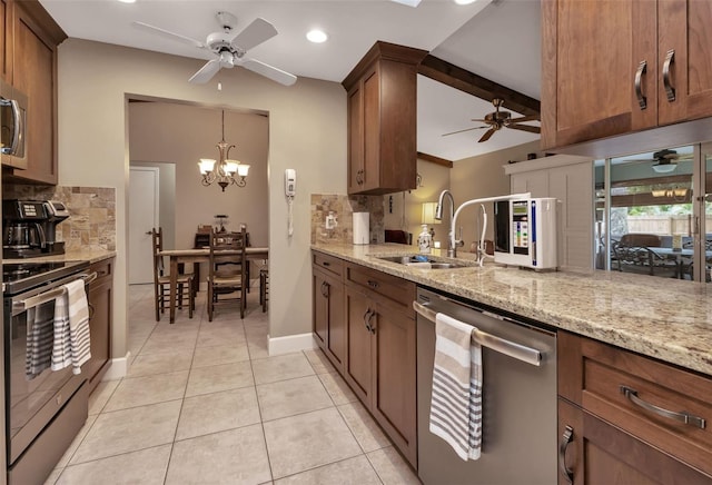 kitchen with tasteful backsplash, appliances with stainless steel finishes, and ceiling fan with notable chandelier