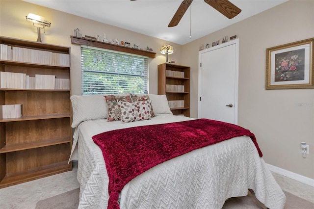 tiled bedroom featuring ceiling fan