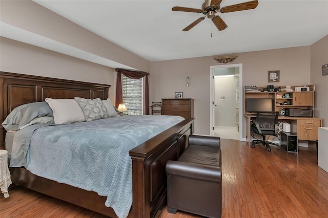 bedroom with hardwood / wood-style floors, ceiling fan, and connected bathroom