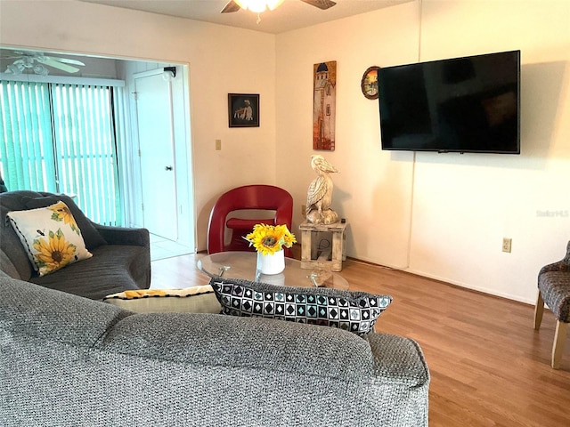 living room with hardwood / wood-style flooring and ceiling fan