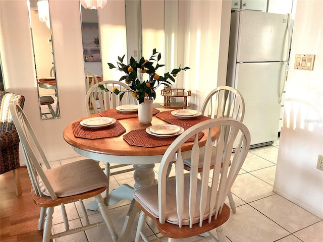 dining area with light tile patterned floors