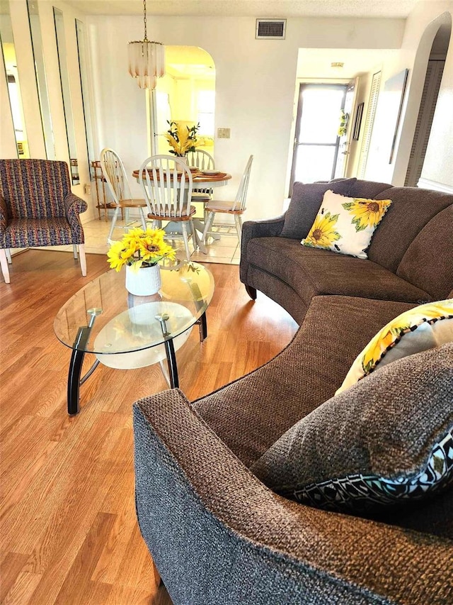 living room featuring hardwood / wood-style flooring and a chandelier