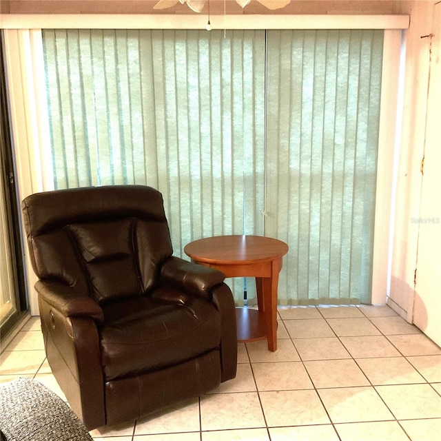 living area featuring ceiling fan and light tile patterned floors