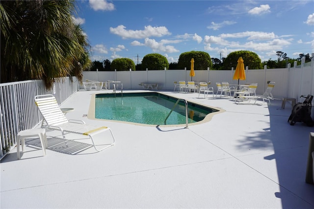 view of swimming pool with a patio area