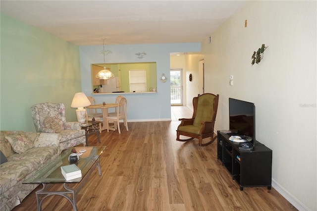 living room featuring a notable chandelier and wood-type flooring