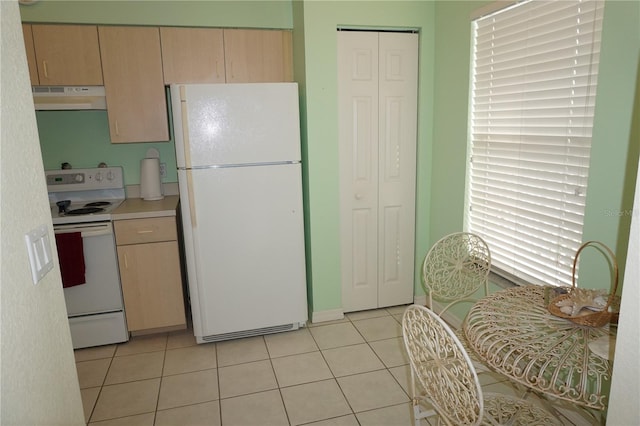 kitchen featuring range hood, light tile flooring, white appliances, and light brown cabinets