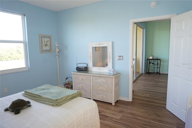 bedroom with dark hardwood / wood-style flooring