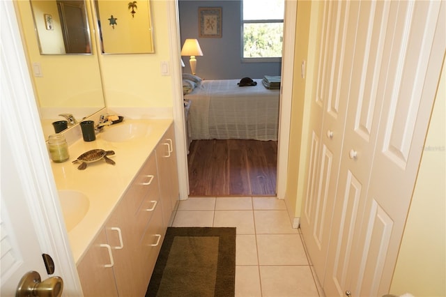 bathroom featuring vanity with extensive cabinet space and tile floors