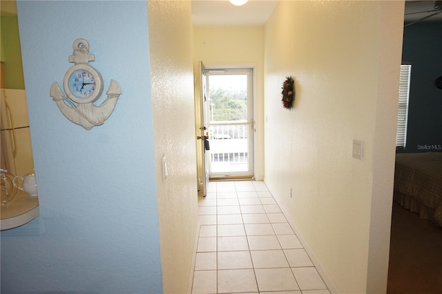 hall featuring light tile floors