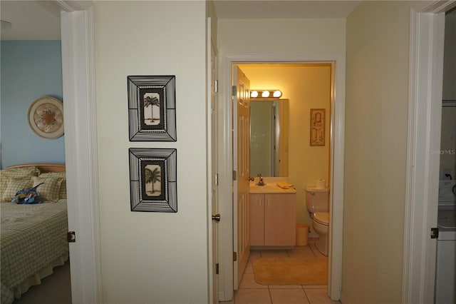 corridor with sink and light tile floors