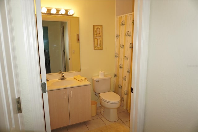 bathroom featuring toilet, vanity with extensive cabinet space, and tile floors